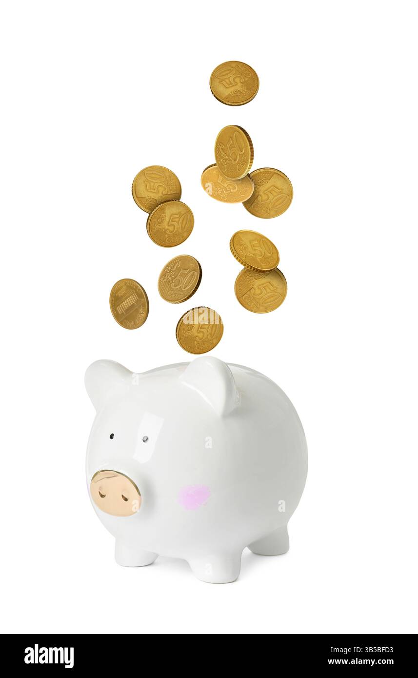 Coins falling into piggy bank on white background Stock Photo - Alamy