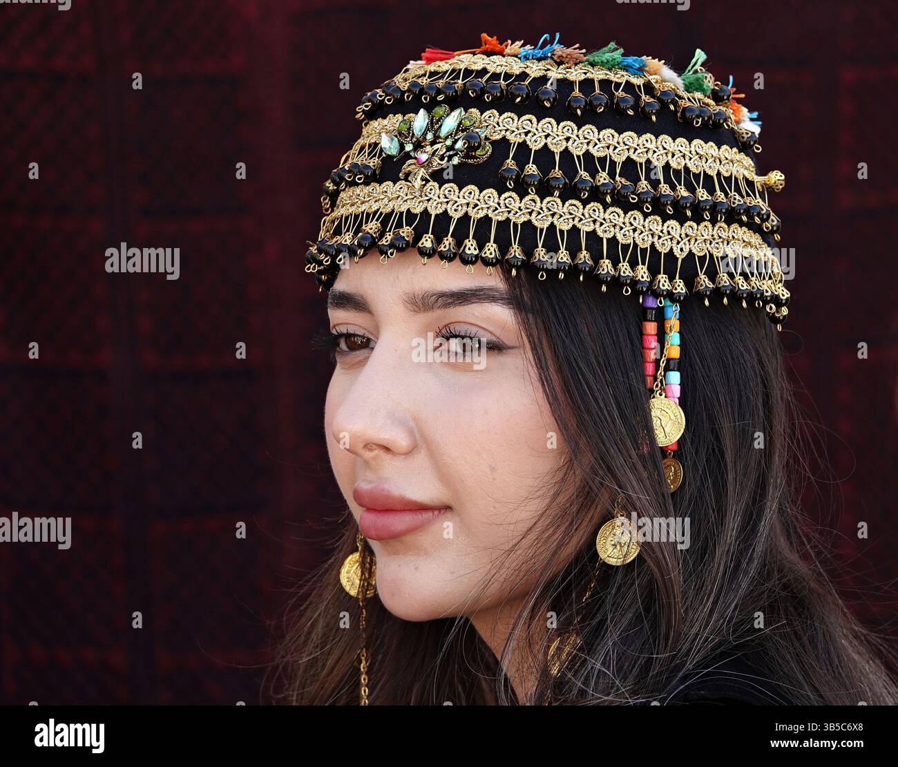A young Kurdish woman is seen displaying women's clothing of Kurds ...