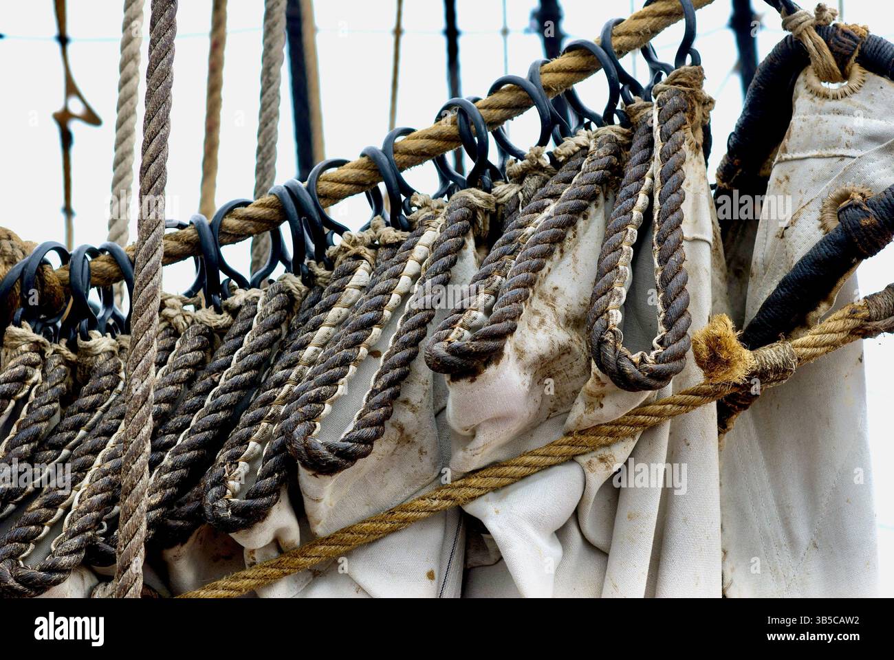 Close-up view of a sailing ship's rigging and sheets while in port ...