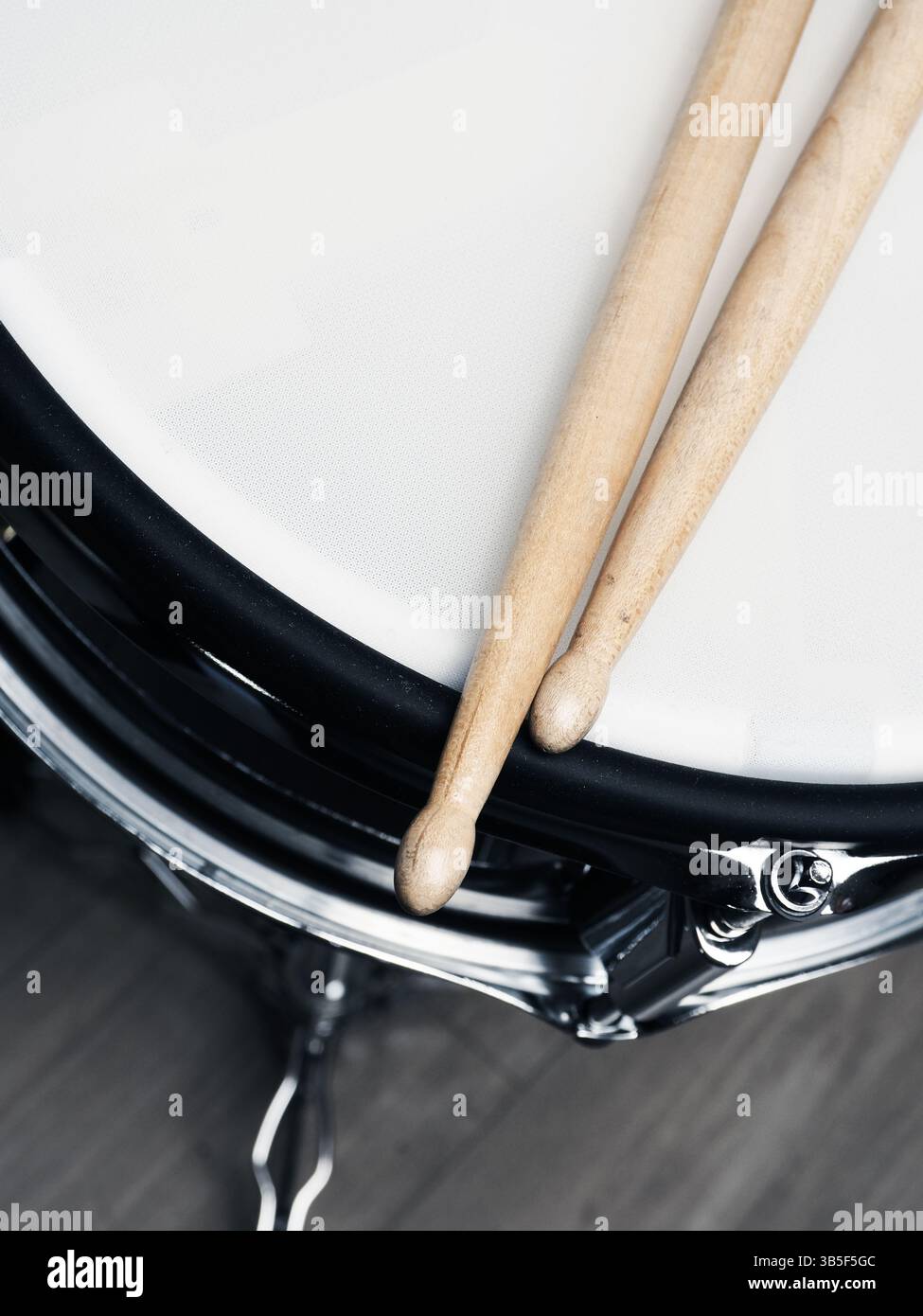 Drum sticks on a snare drum, close up shot, musician or drummer concept ...
