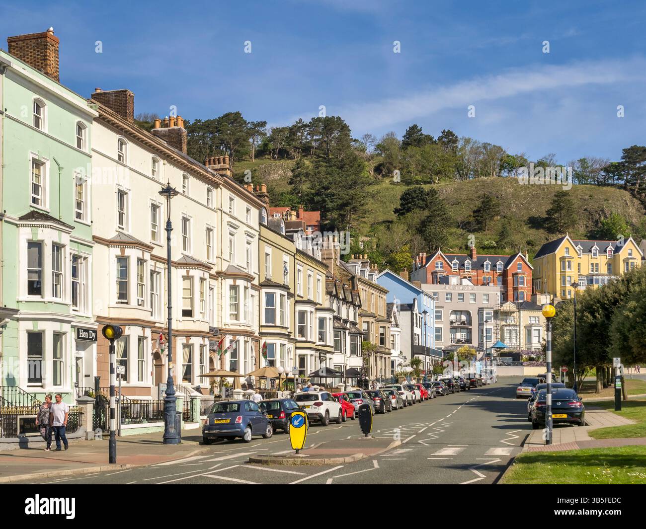 Llandudno, North Wales, UK - Seaside guest houses in North Parade during a spell of very warm weather in April 2025. In the background is the Great... Stock Photo