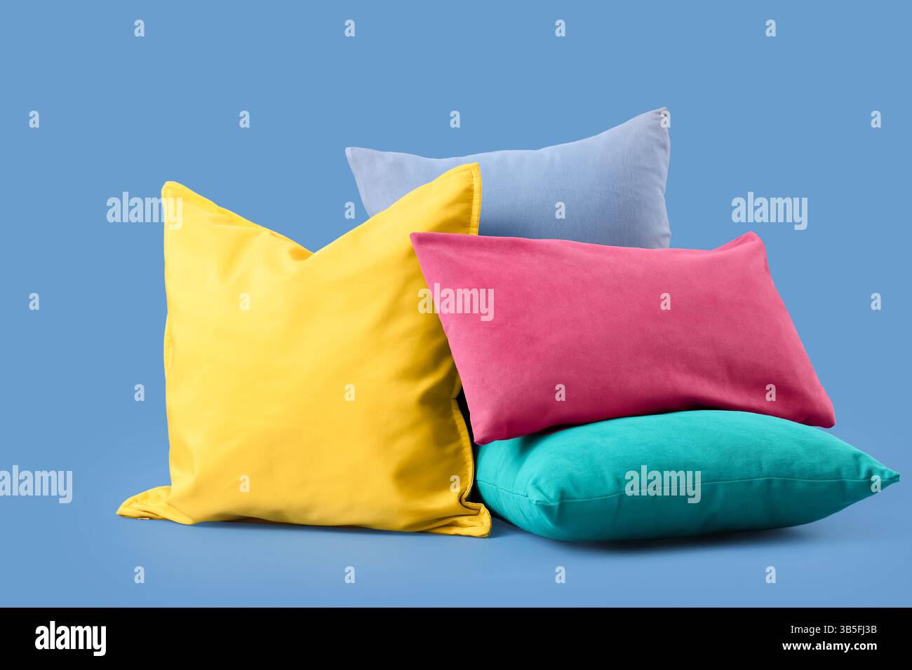 Different colorful pillows on blue background Stock Photo