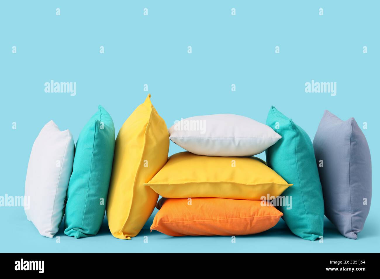 Different colorful pillows on blue background Stock Photo