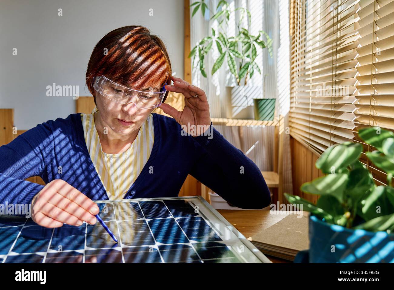 Business woman wearing augmented reality glasses analysis solar panel ...