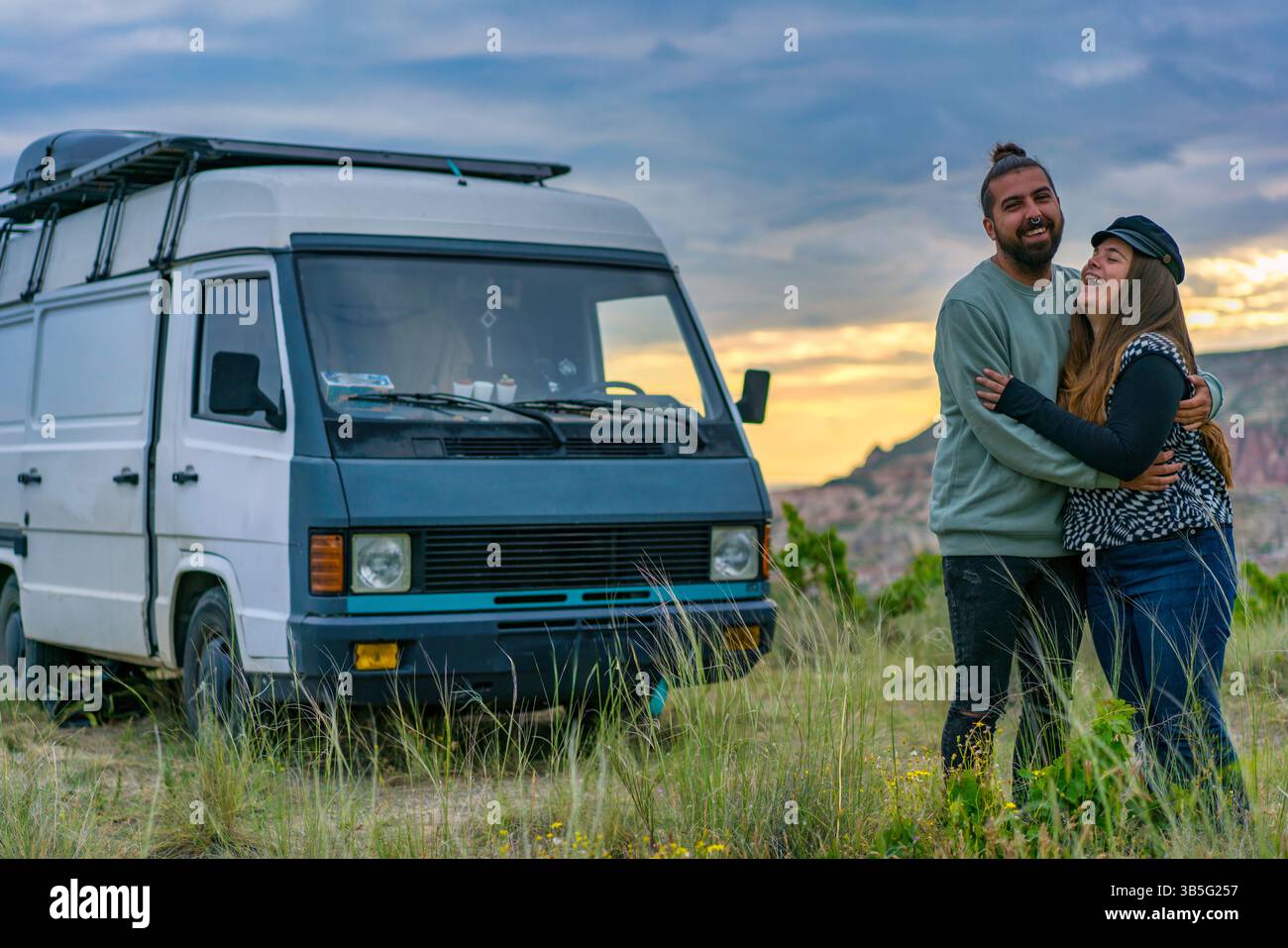 Couple hugging and laughing in front of camper van in Cappadocia Stock ...