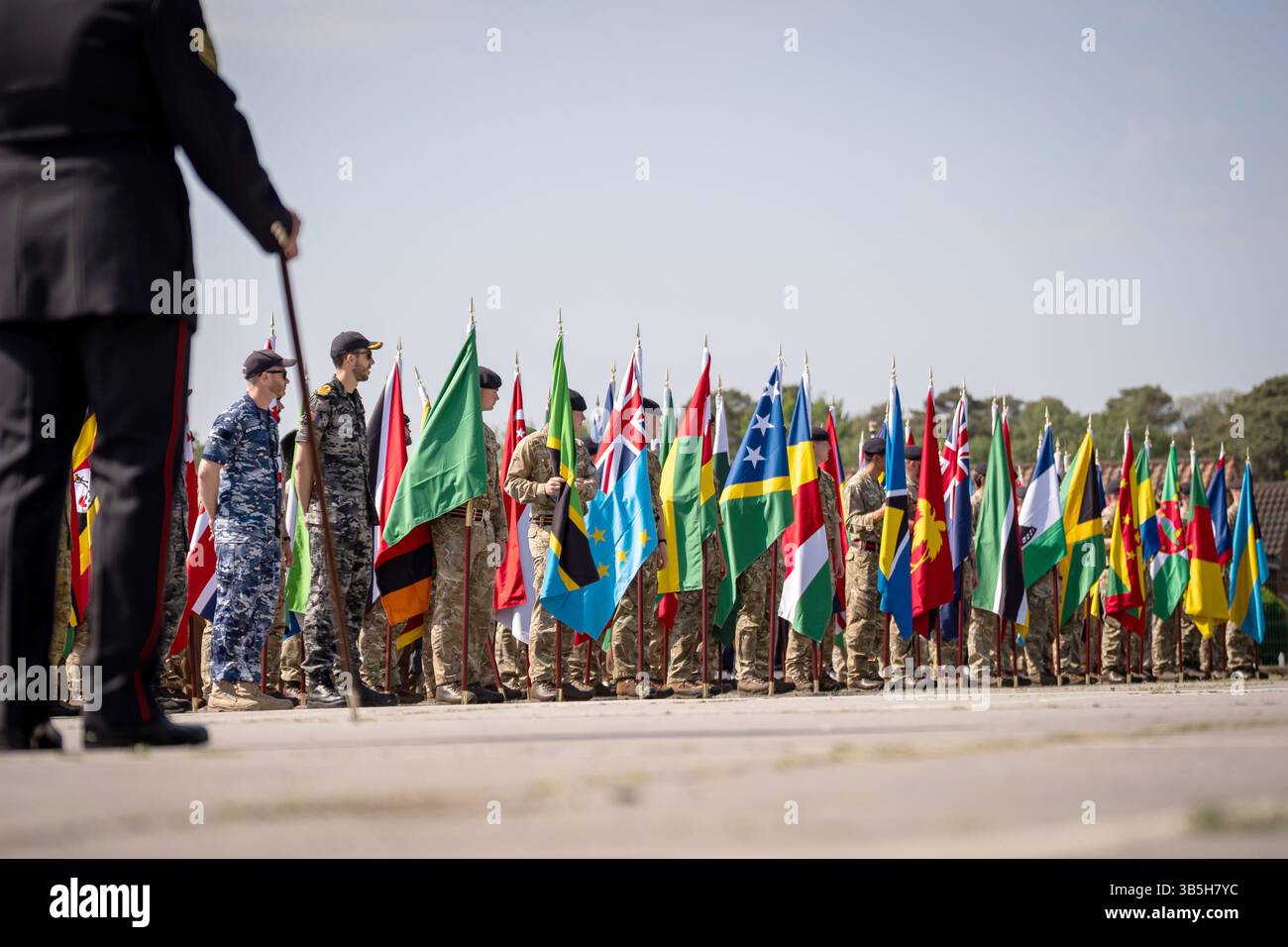 Members of the Armed Forces carry flags as they take part in a ...