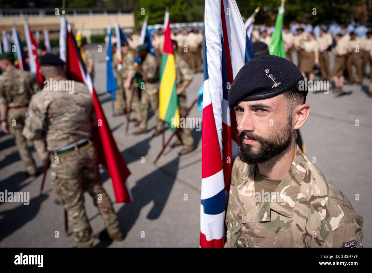 Members of the Armed Forces carry flags as they take part in a ...