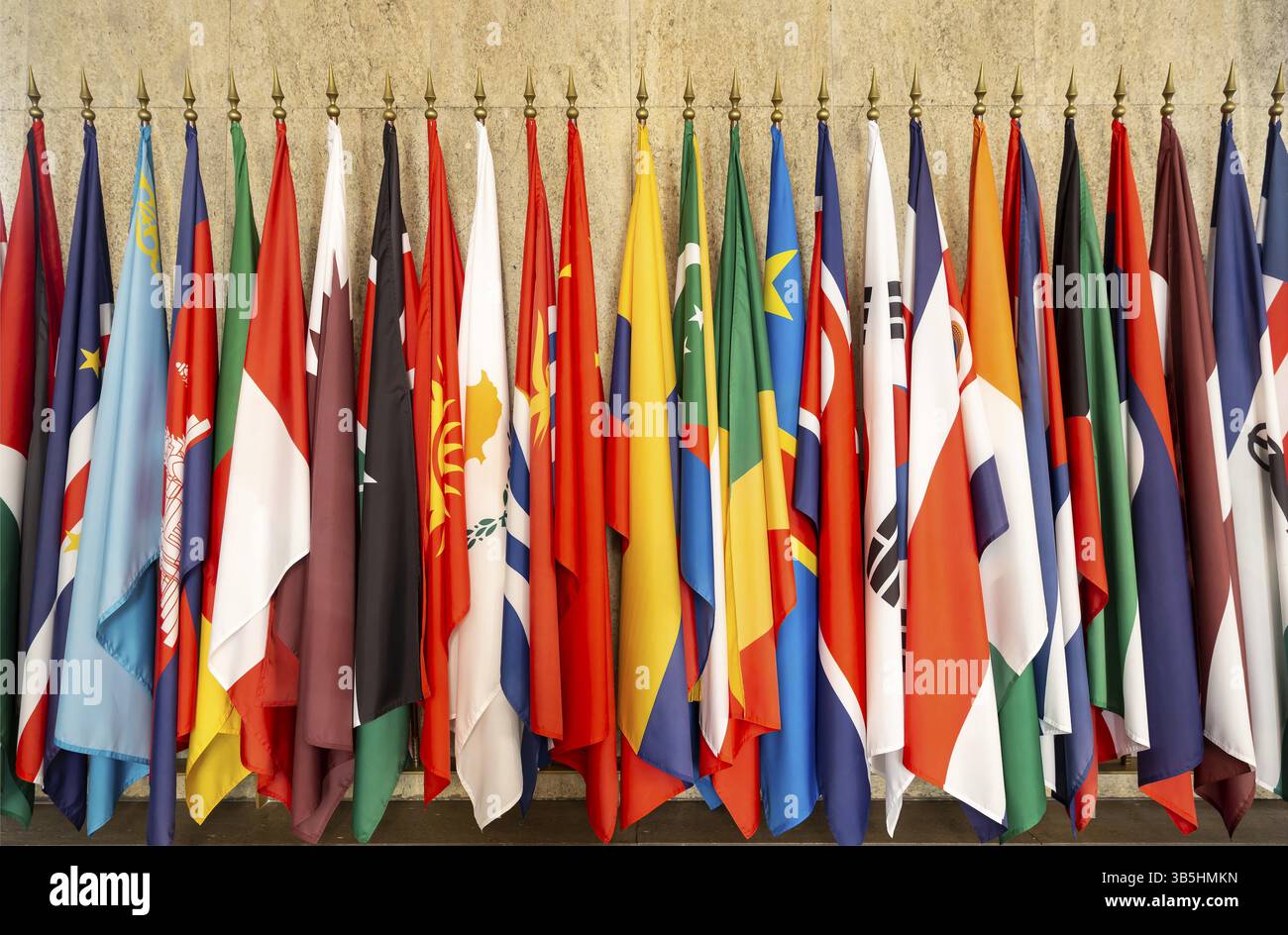 Some world national flags on poles on a wall Stock Photo - Alamy