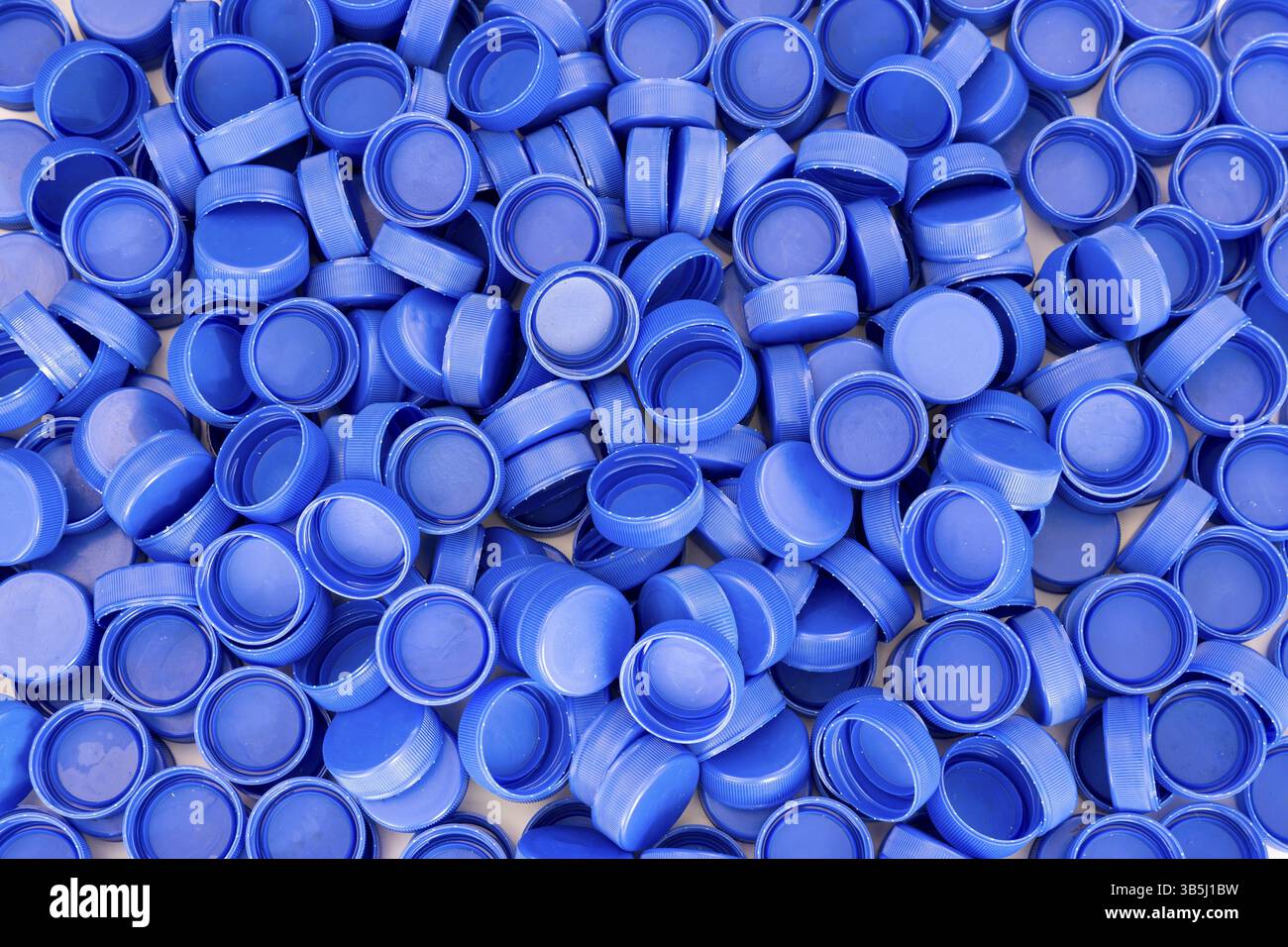 Blue plastic bottle caps. Studio shot. Plastic waste Stock Photo - Alamy