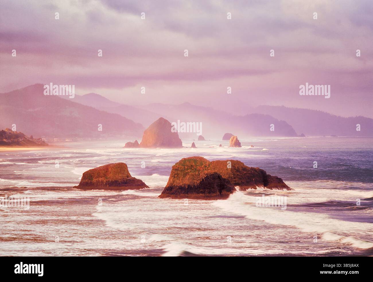 Sunrise and clouds  and fog with waves. Cannon Beach. Oregon Stock Photo