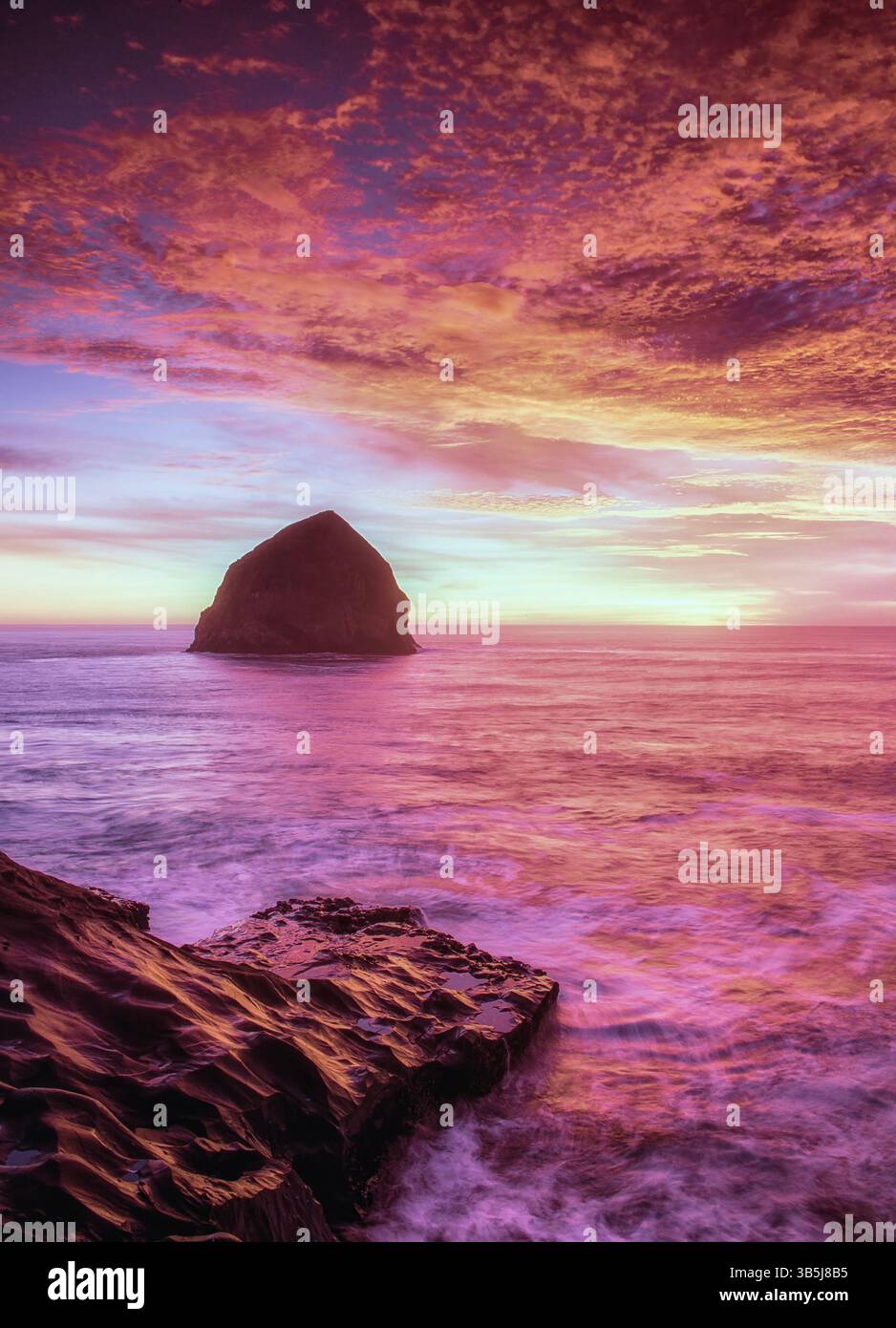 Sunset at Cape Kiwanda beach with Haystack Rock, Oregon. Stock Photo
