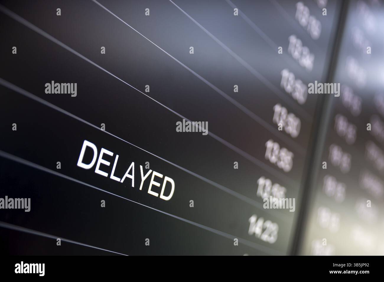 Boarding time monitor screens - timetable boards. Arrivals and departures monitors to check the status of a flight on the airport. Delayed sign Stock Photo