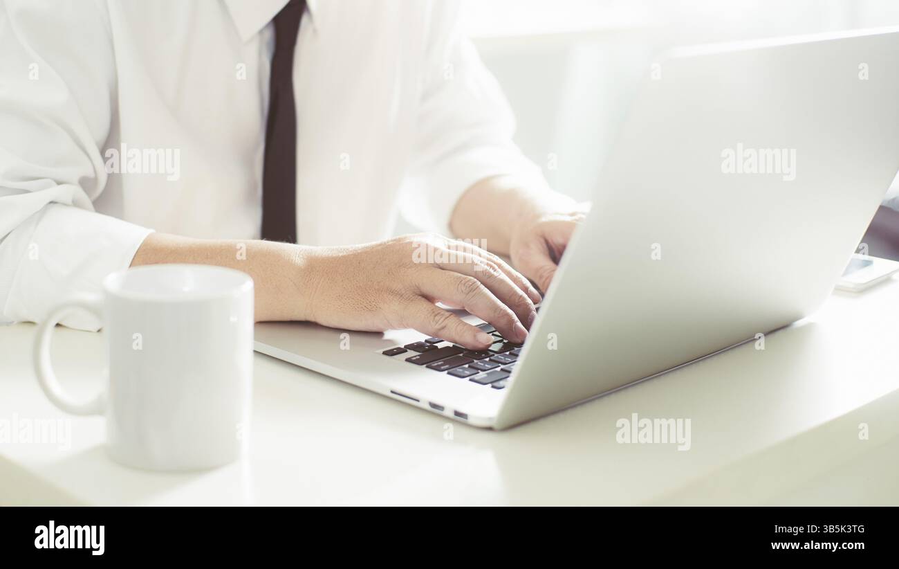 Businessman hands working on laptop, Blurred background Stock Photo