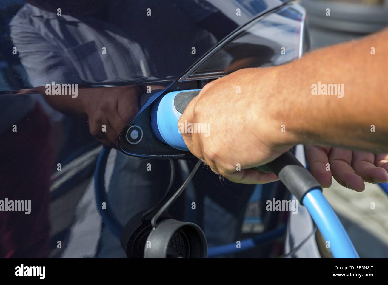 Electric car charging. Electric vehicle charging station. Human hand ...