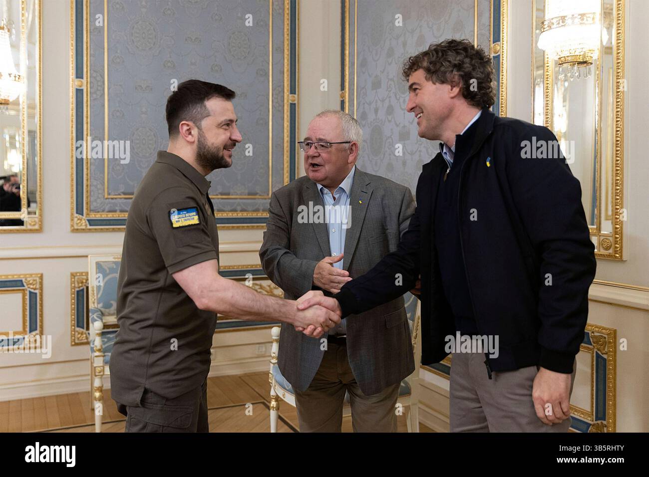 May 20, 2022, Kyiv, Ukraine: Ukrainian President Volodymyr Zelenskyy, shakes hands with Senator Mark Daly, right, leader of the Irish Senate as Sean O Fearghail, center, Chairperson of the Lower House of the Irish Parliament looks on at the Mariinsky Palace, May 20, 2022 in Kyiv, Ukraine. (Credit Image: © Ukraine Presidency/Ukraine Presi/Planet Pix via ZUMA Press Wire) Stock Photo