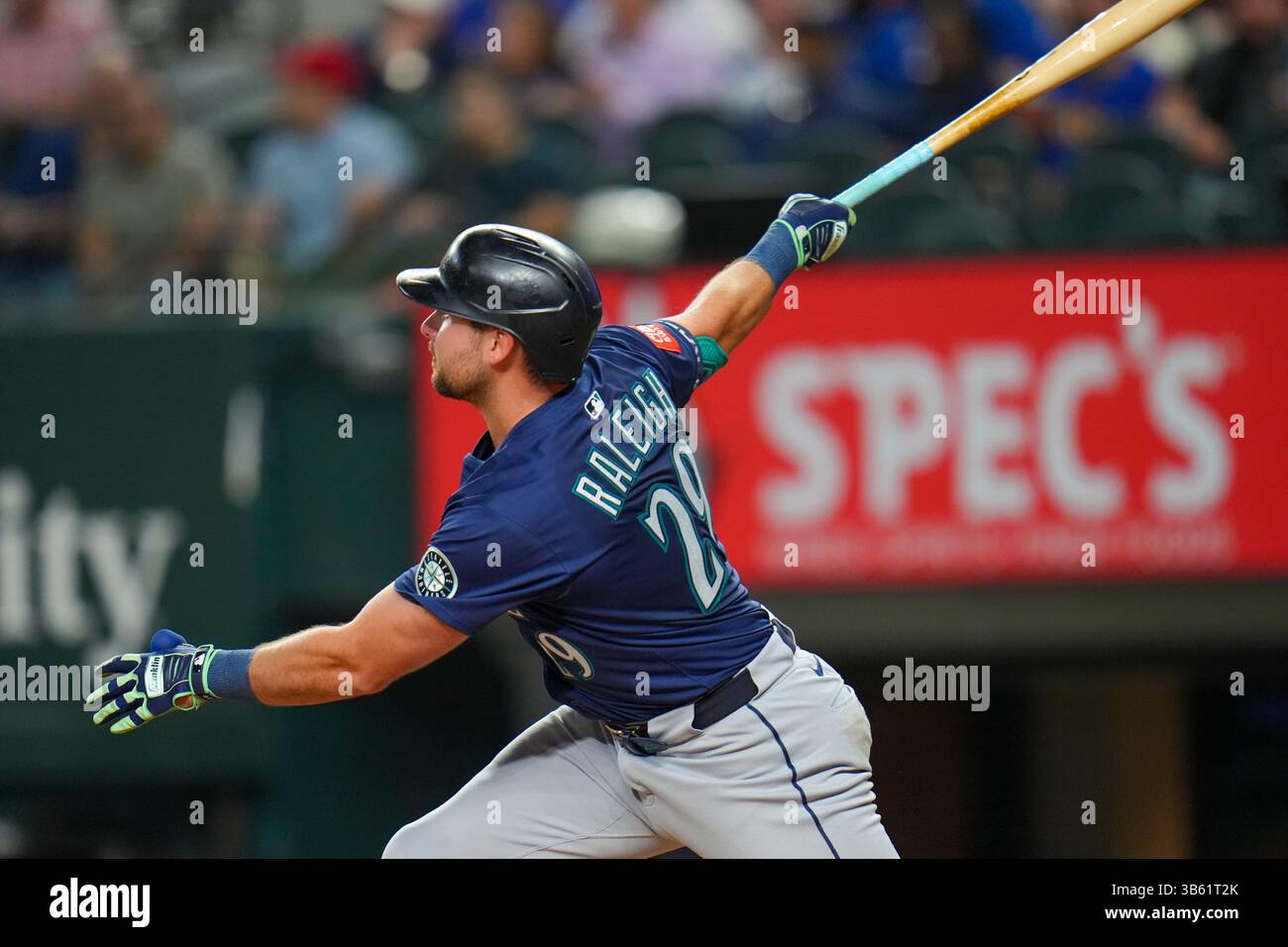 Seattle Mariners' Cal Raleigh follows through while hitting a grand ...