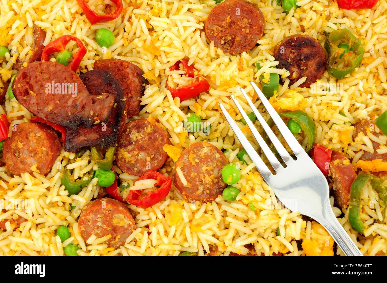 Egg fried rice with spicy chorizo salami and Chilli peppers background Stock Photo