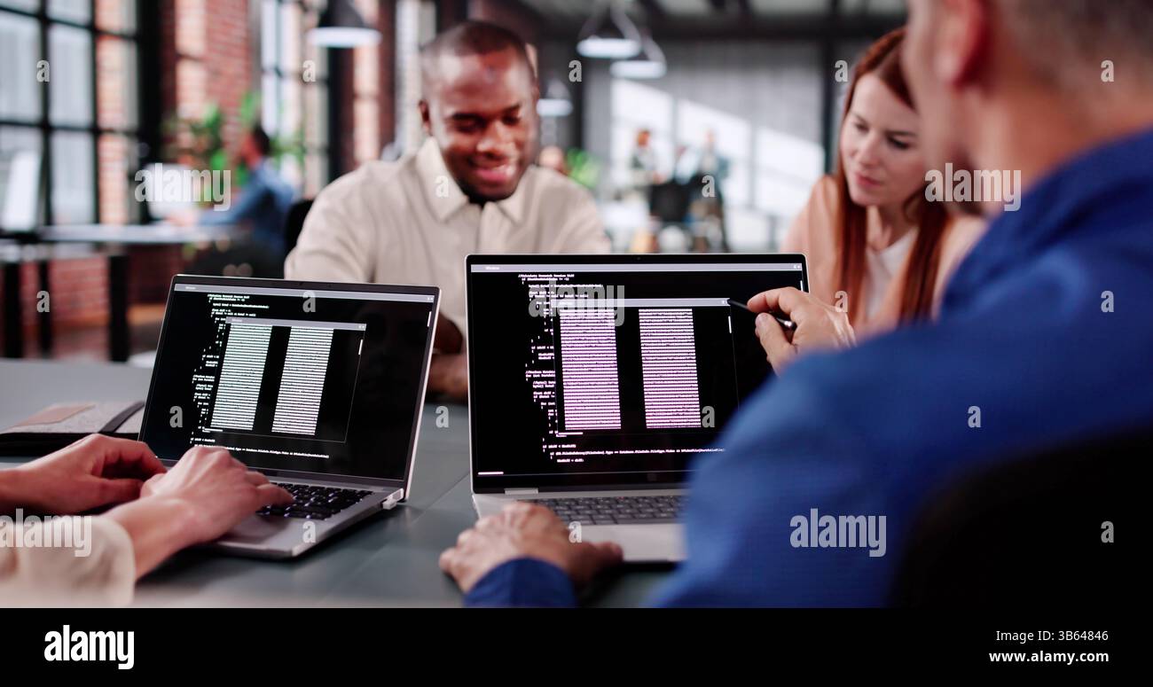 Collaborative Coding Session In Tech Startup With Multiracial Programmers Working Stock Photo