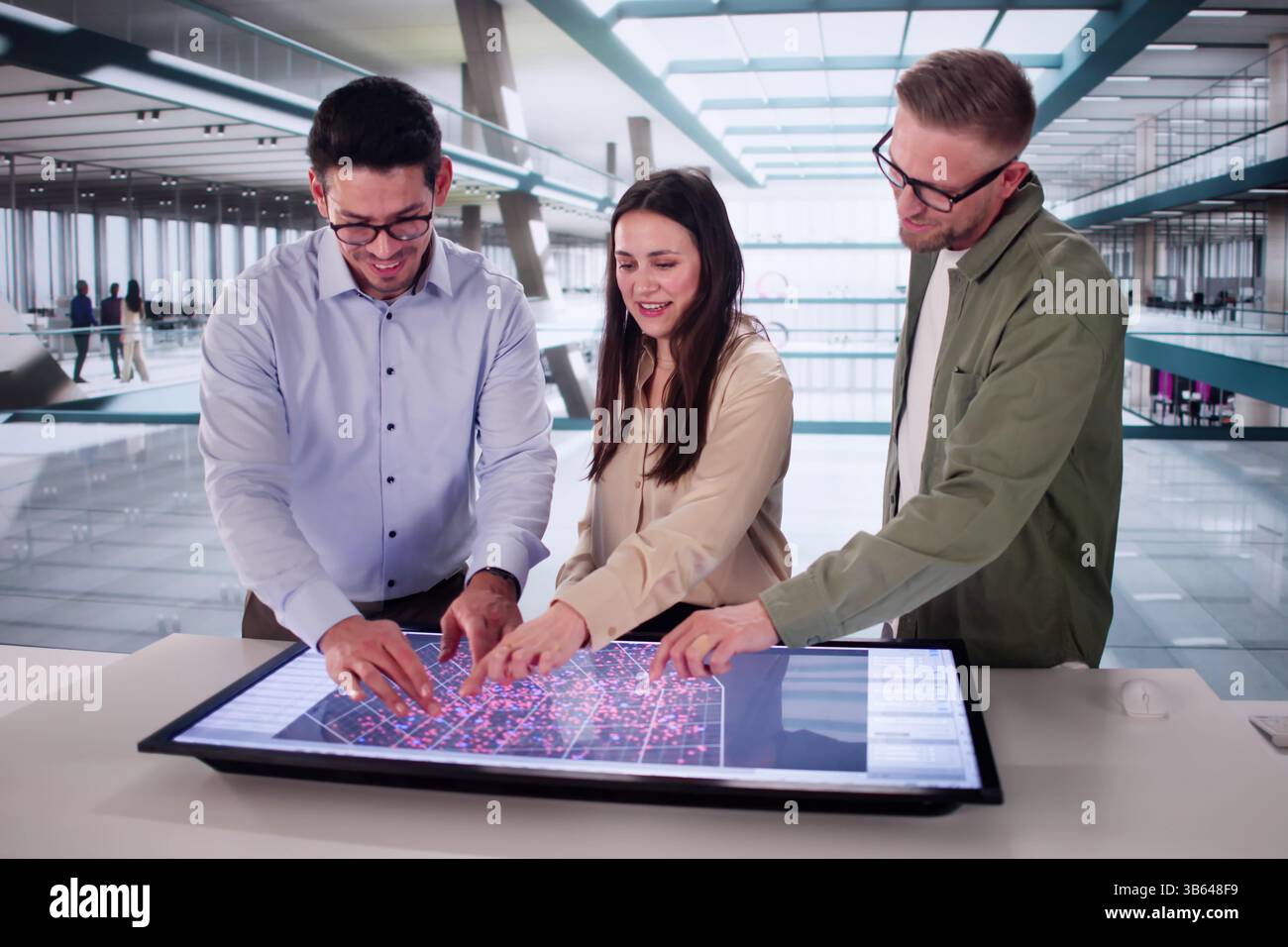 Hispanic Engineer Uses Computer To Analyze Big Data In Factory. Stock Photo