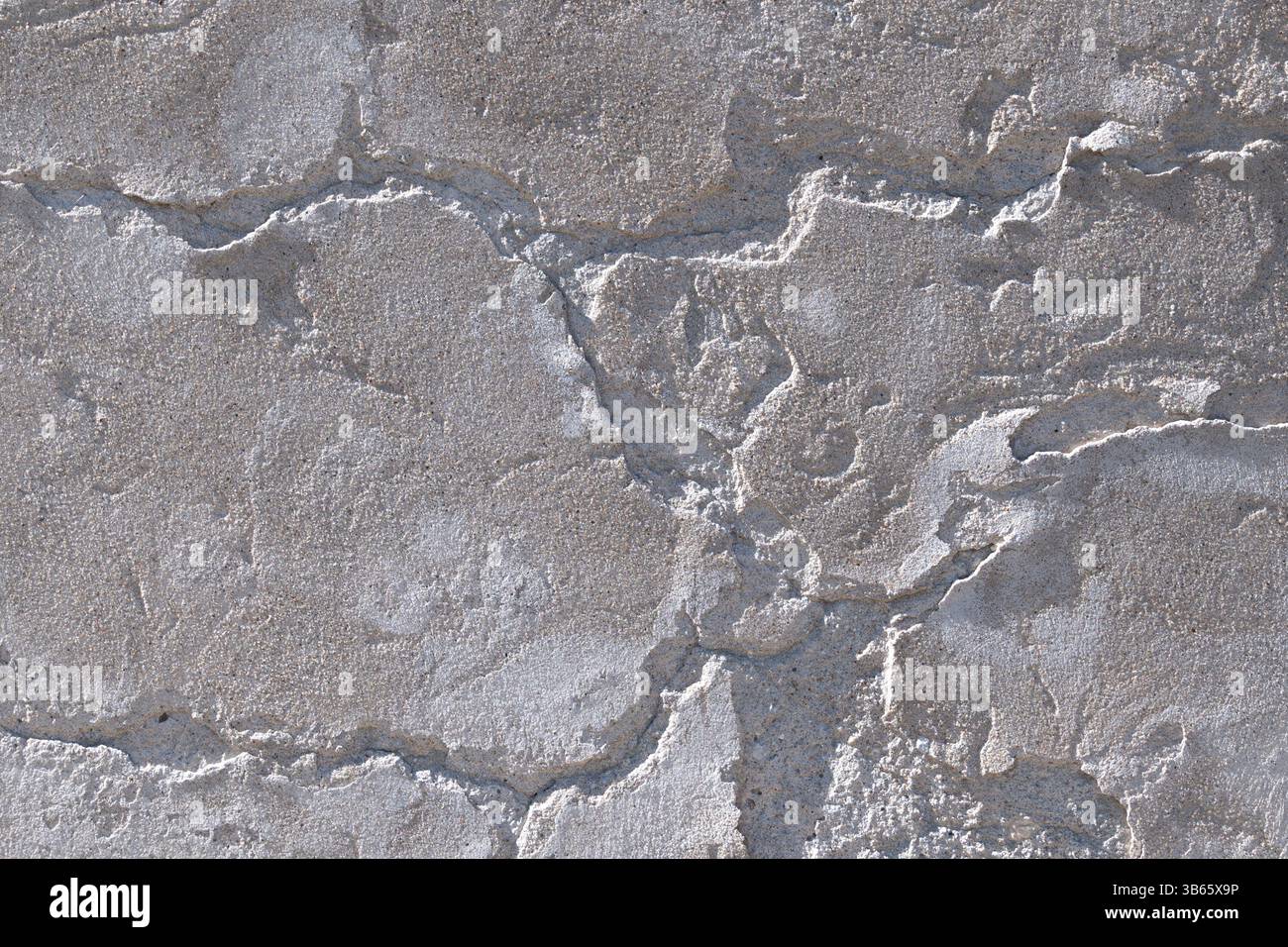 Weathered gray concrete surface with deep cracks, rough texture, and visible erosion from aging and elements. Backgrounds Stock Photo