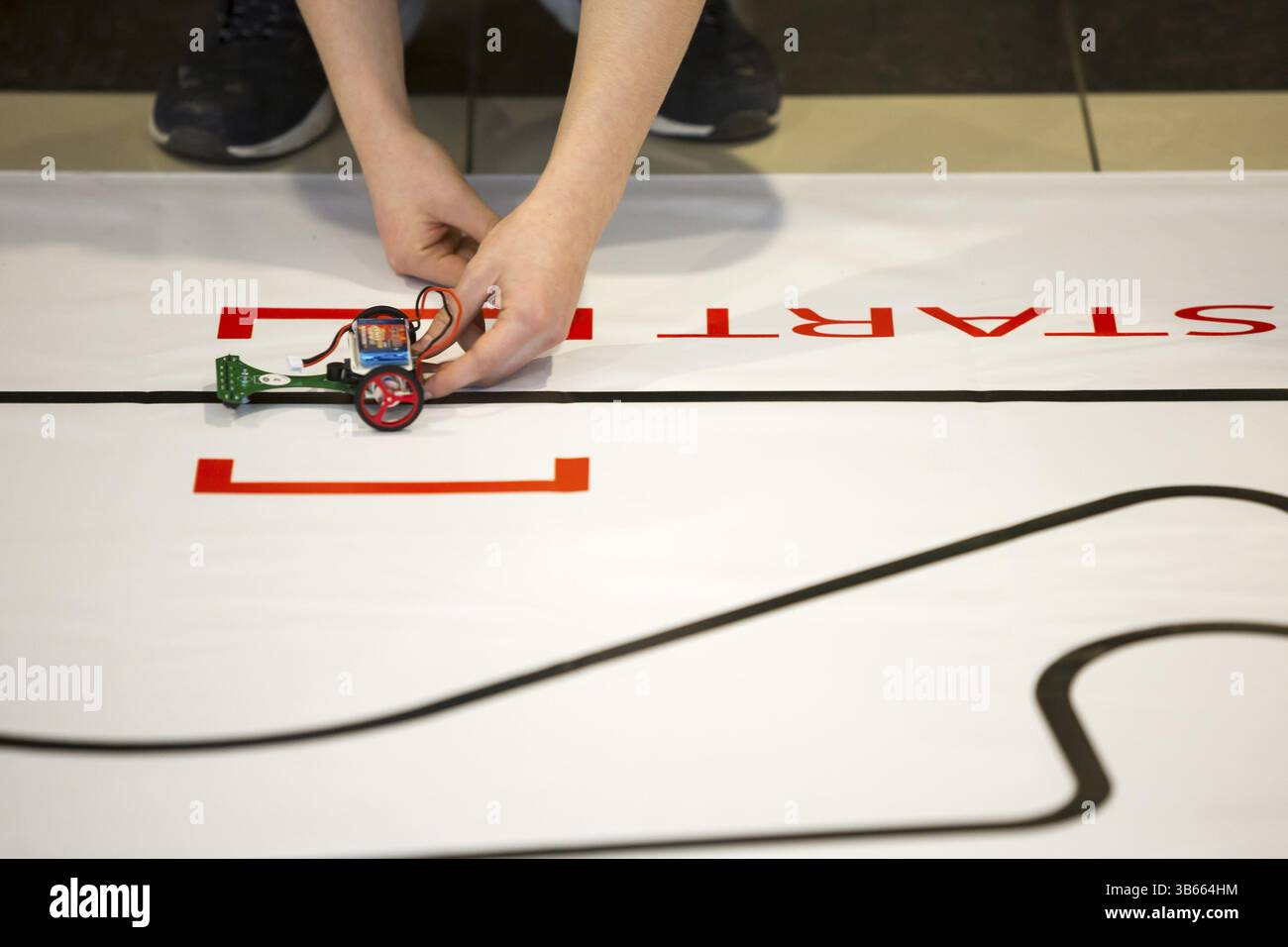 Sofia, Bulgaria - December 17, 2016: A student prepares his race robot during an open competition of self-made robots among school students Stock Photo