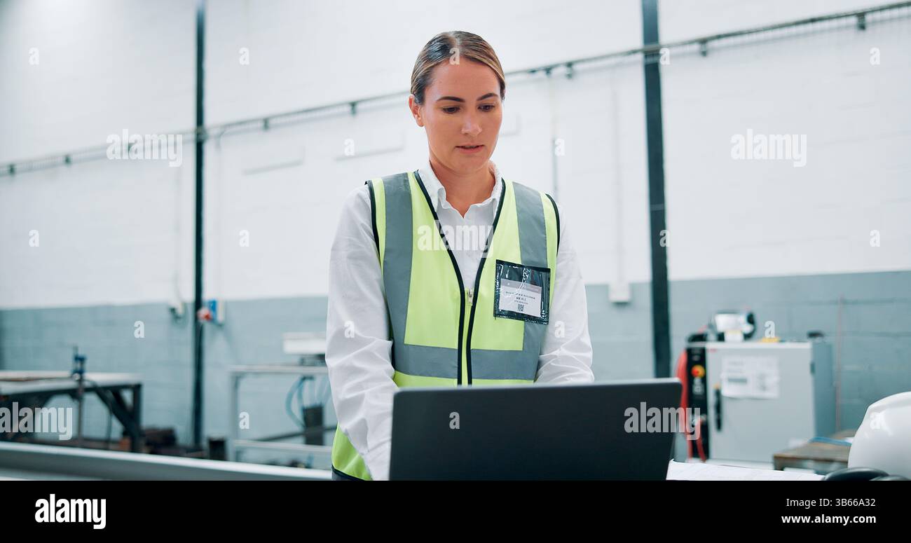 Engineer, laptop and woman in factory for robotics, manufacturing and ...
