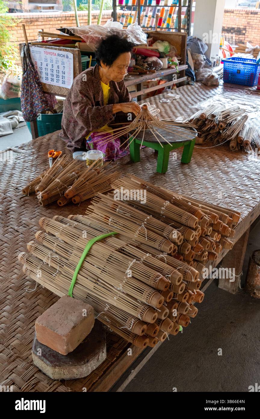 Applying thread onto the bamboo ribs and spokes at the Bo Sang Umbrella ...