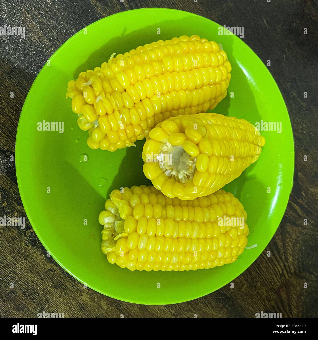 Sweet boiled corn served on green plate - Smartphone Captured Stock Image