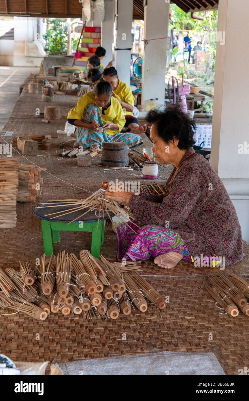 Applying thread onto the bamboo ribs and spokes at the Bo Sang Umbrella ...