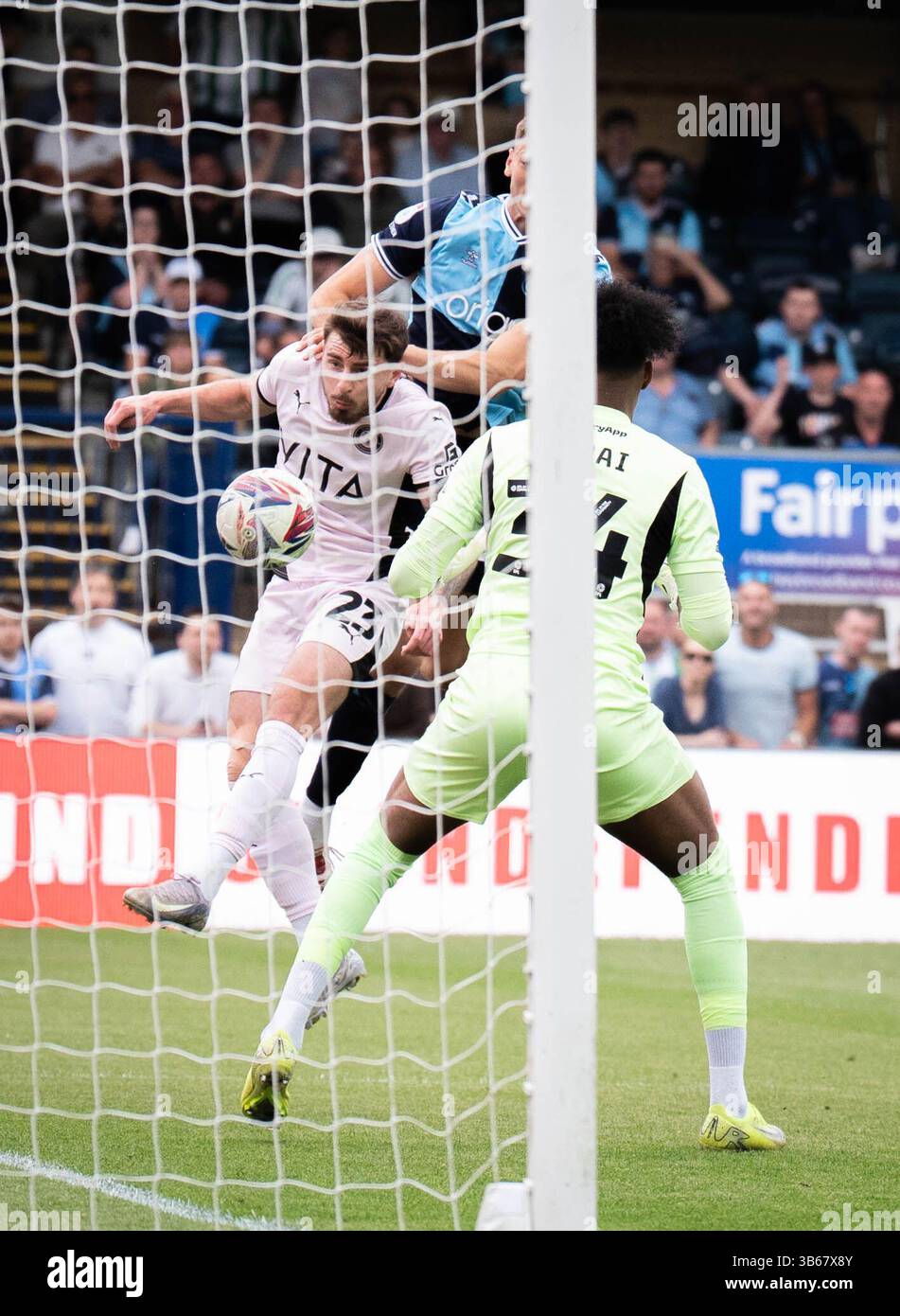Ryan Rydel Stockport County's Ryan Rydel (left) headers the ball into the goal to ...