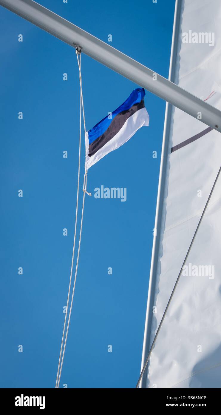 Estonian flag waving in wind and sunlight on a sailing boat. Flag of ...