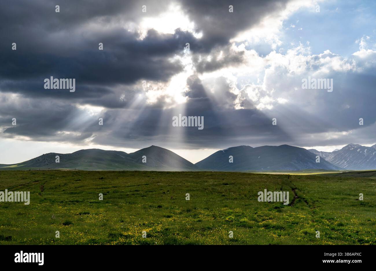 A serene landscape featuring rolling green hills under a dramatic sky ...