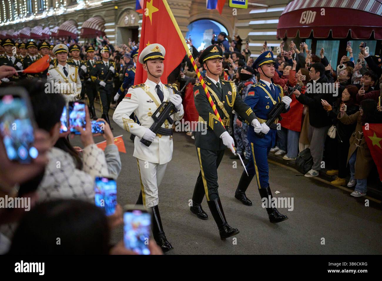 Chinese People's Liberation Army soldiers march past the GUM department ...