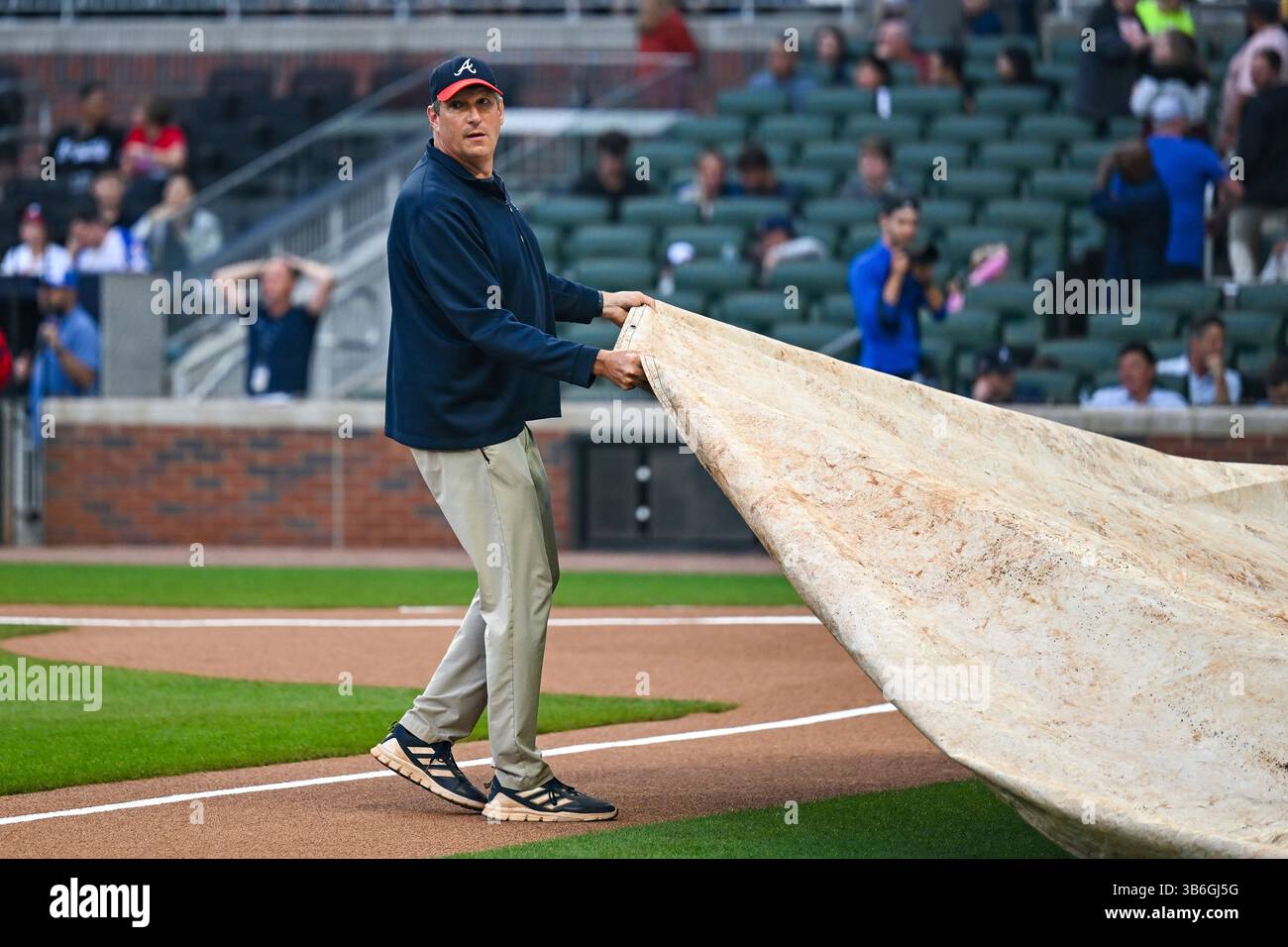 ATLANTA, GA – MAY 03: A member of the Braves grounds crew pulls the ...