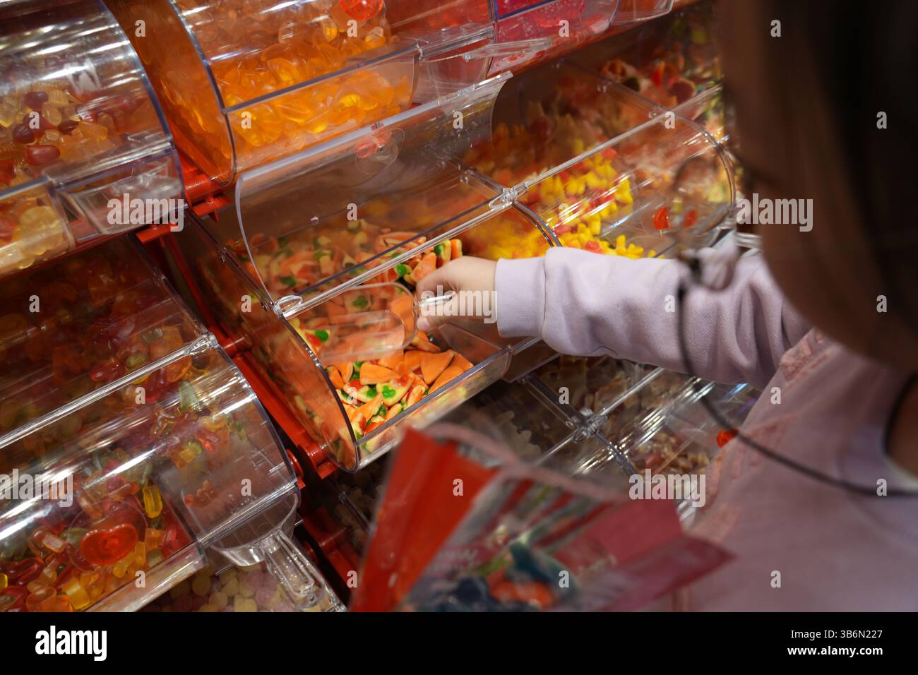 Girl puts sweets in hi-res stock photography and images - Alamy