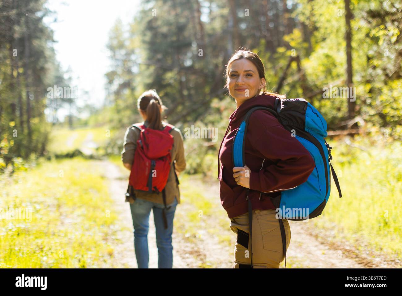 Two hikers traverse forest hi-res stock photography and images - Alamy