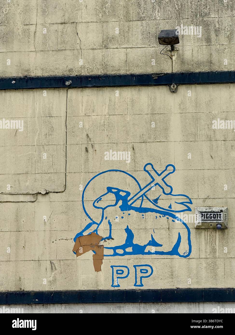Symbol of Preston ( lamb and cross with letters PP) painted on wall in blue. Part of the Preston coat of arms - Smartphone Captured Stock Image