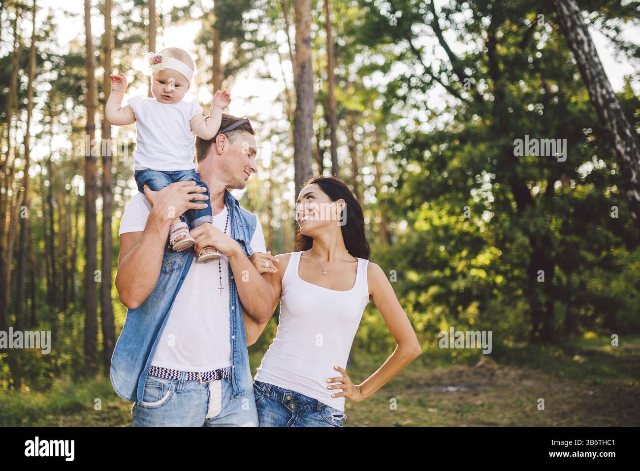 Stylish young Family of mom, dad and daughter one year old blonde ...