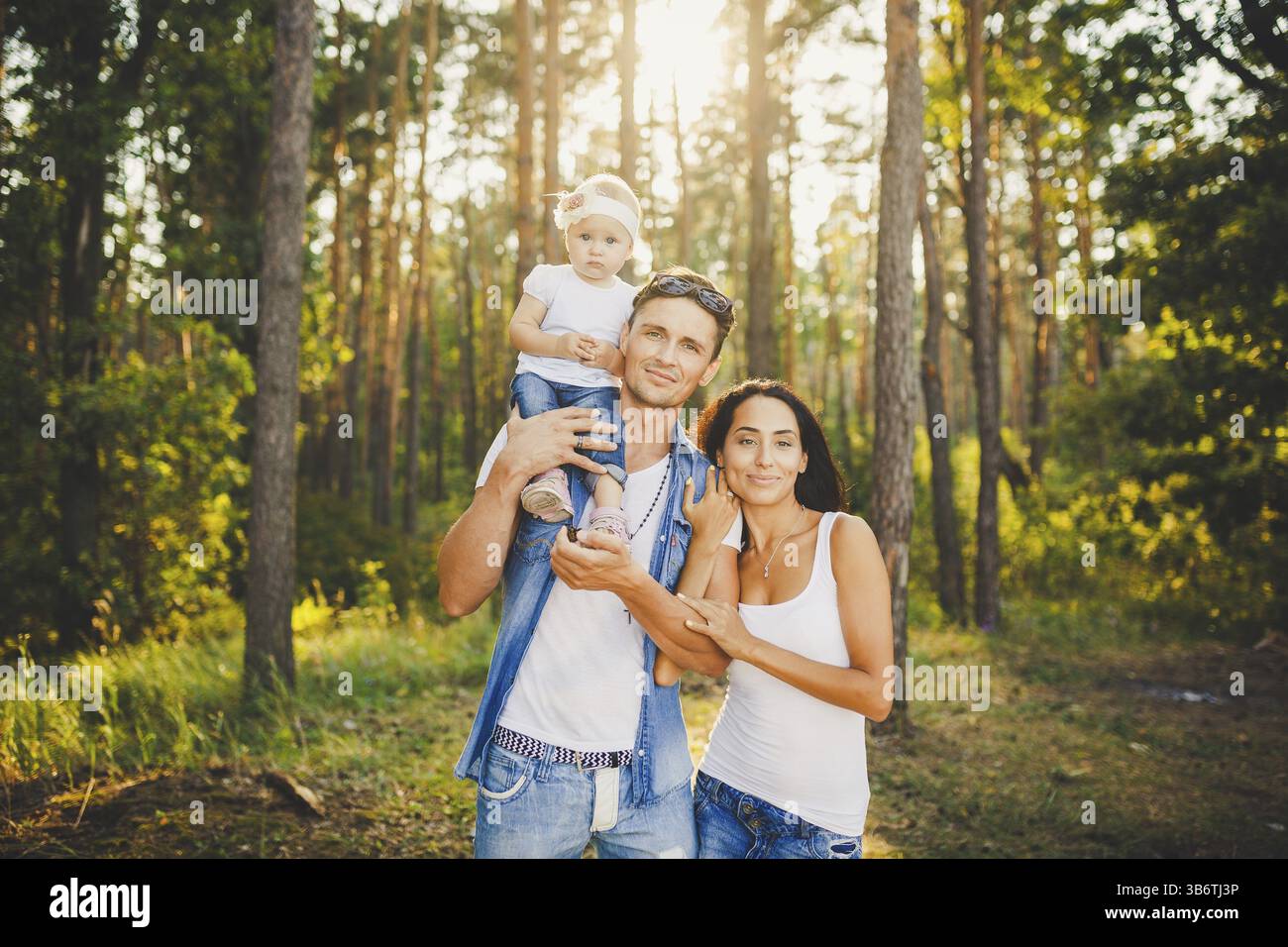Stylish young Family of mom, dad and daughter one year old blonde ...