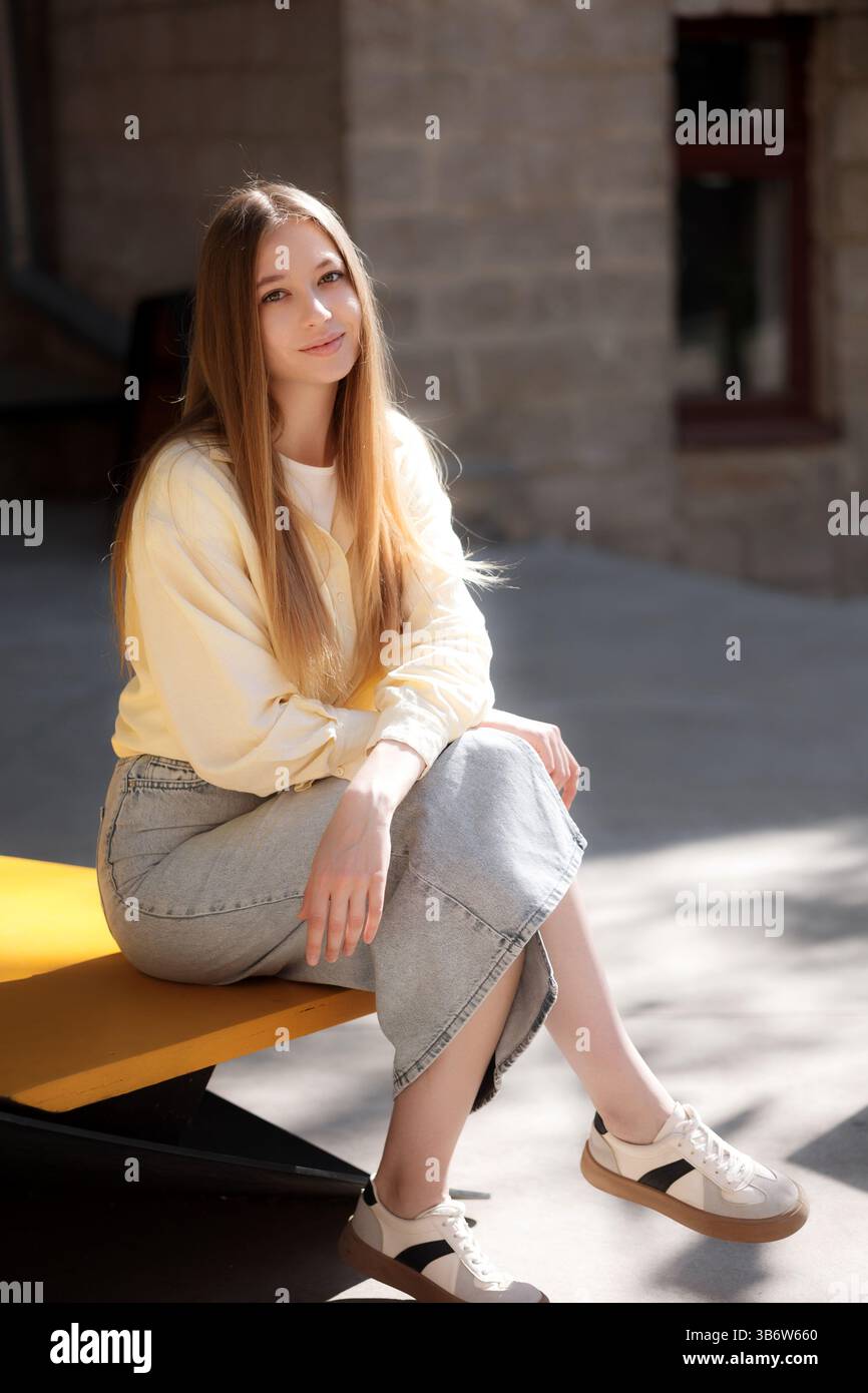 Woman in yellow sweater wearing hi-res stock photography and images - Alamy