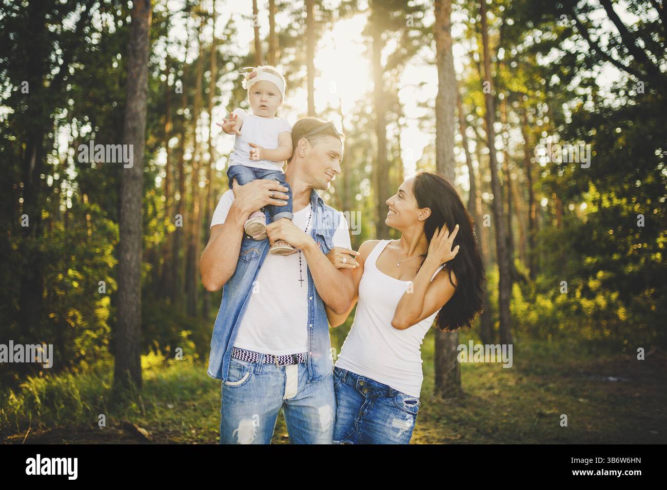 Stylish young Family of mom, dad and daughter one year old blonde ...