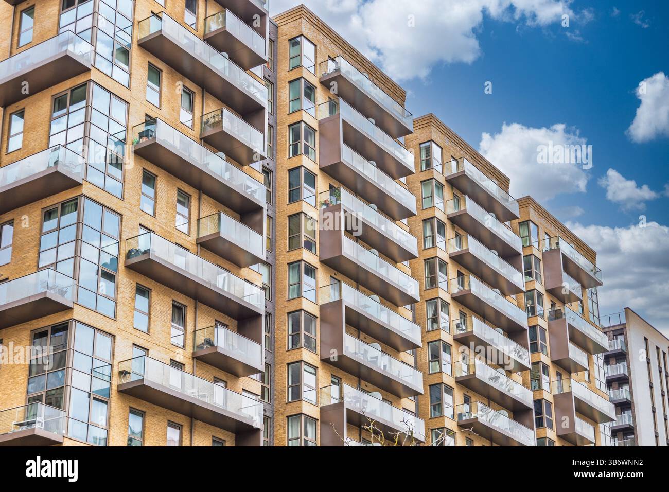 Contemporary residential apartment complex featuring glass balconies ...