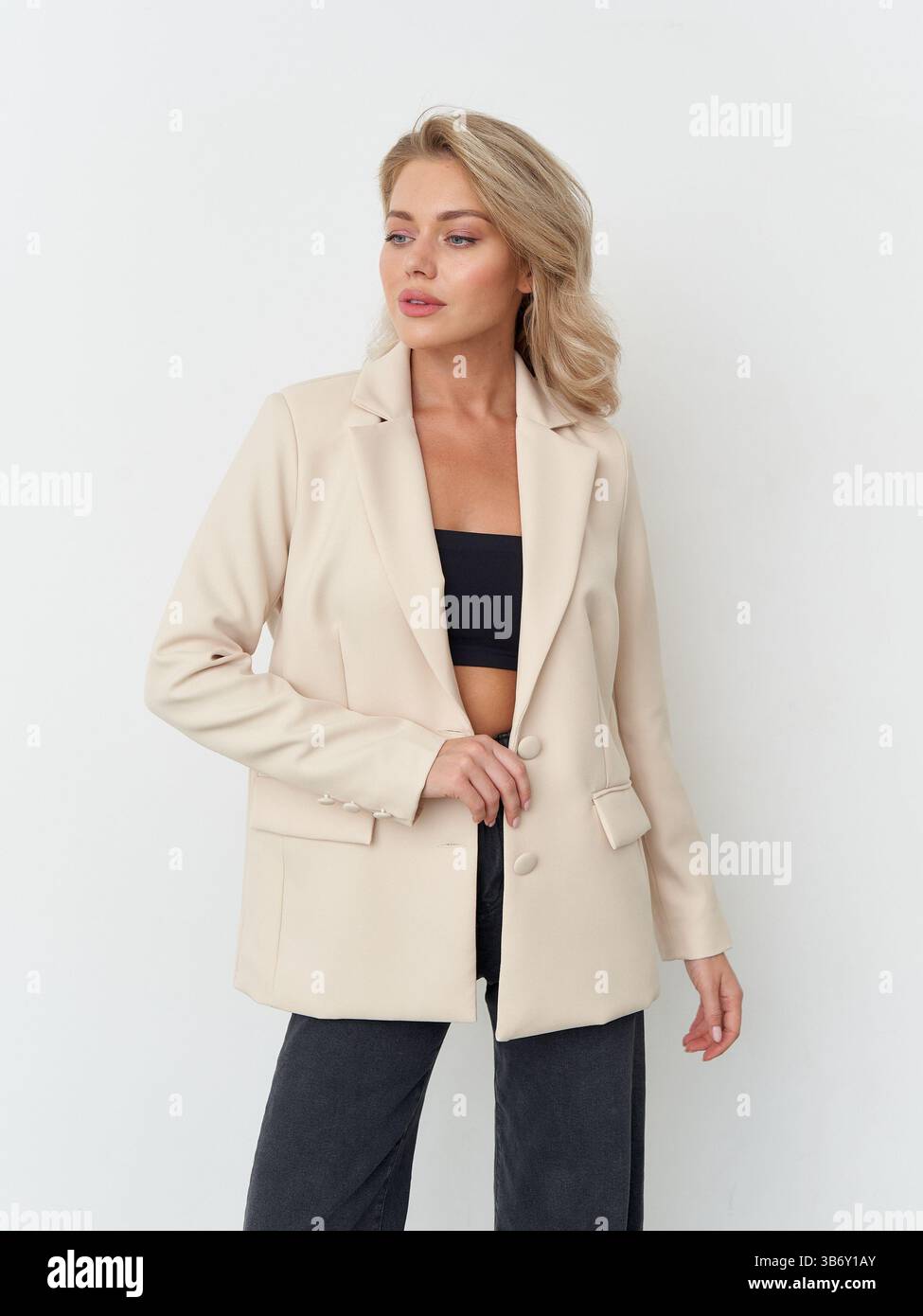 Elegant fashion model poses confidently in chic studio setting with ...
