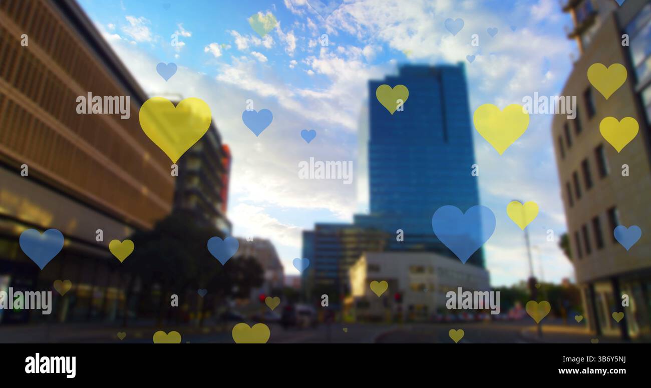 Image of yellow and blue hearts floating over cityscape Stock Photo - Alamy