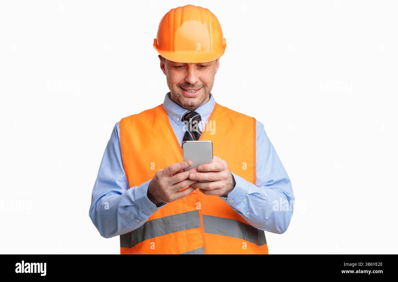 Construction Worker Using Smartphone Standing On White Studio Background Stock Photo