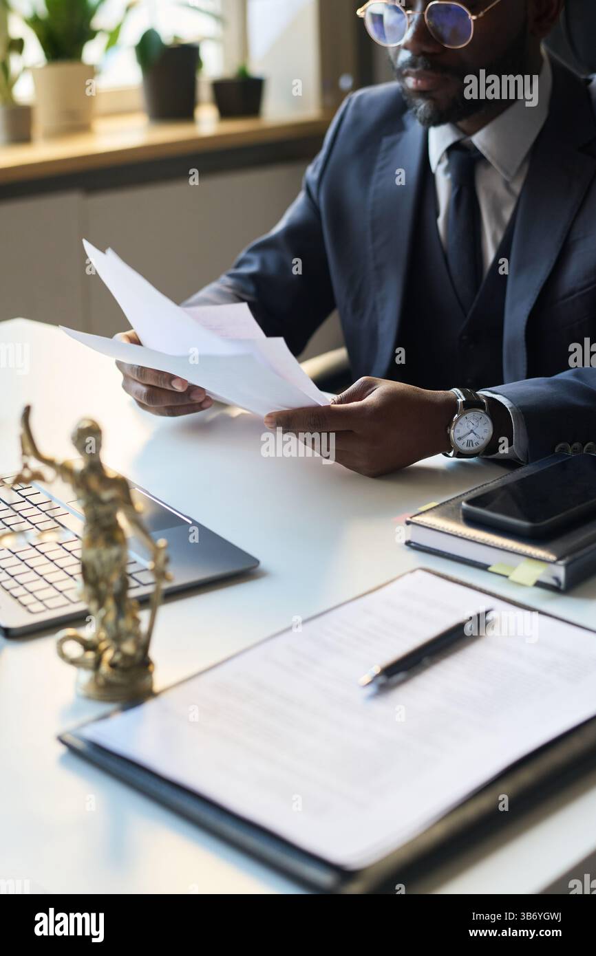 Black Man Looking Through Legal Documents Stock Photo - Alamy