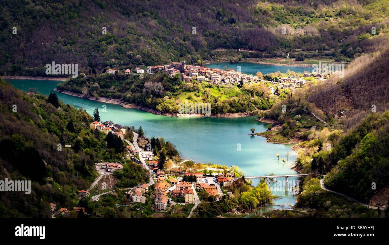 Aerial view of a picturesque village nestled between lush green hills ...