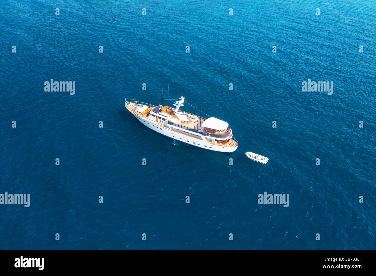 Aerial view of a luxurious yacht sailing on calm, deep blue ocean Stock ...