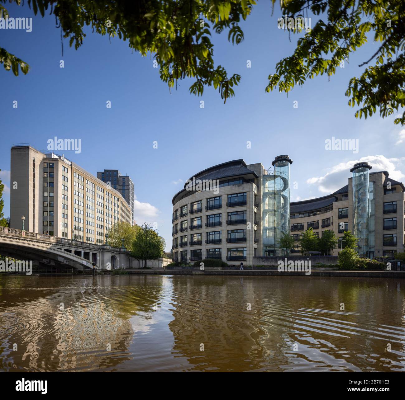 Modern Riverside Building Riverside scene featuring modern curved office buildings with glass ...