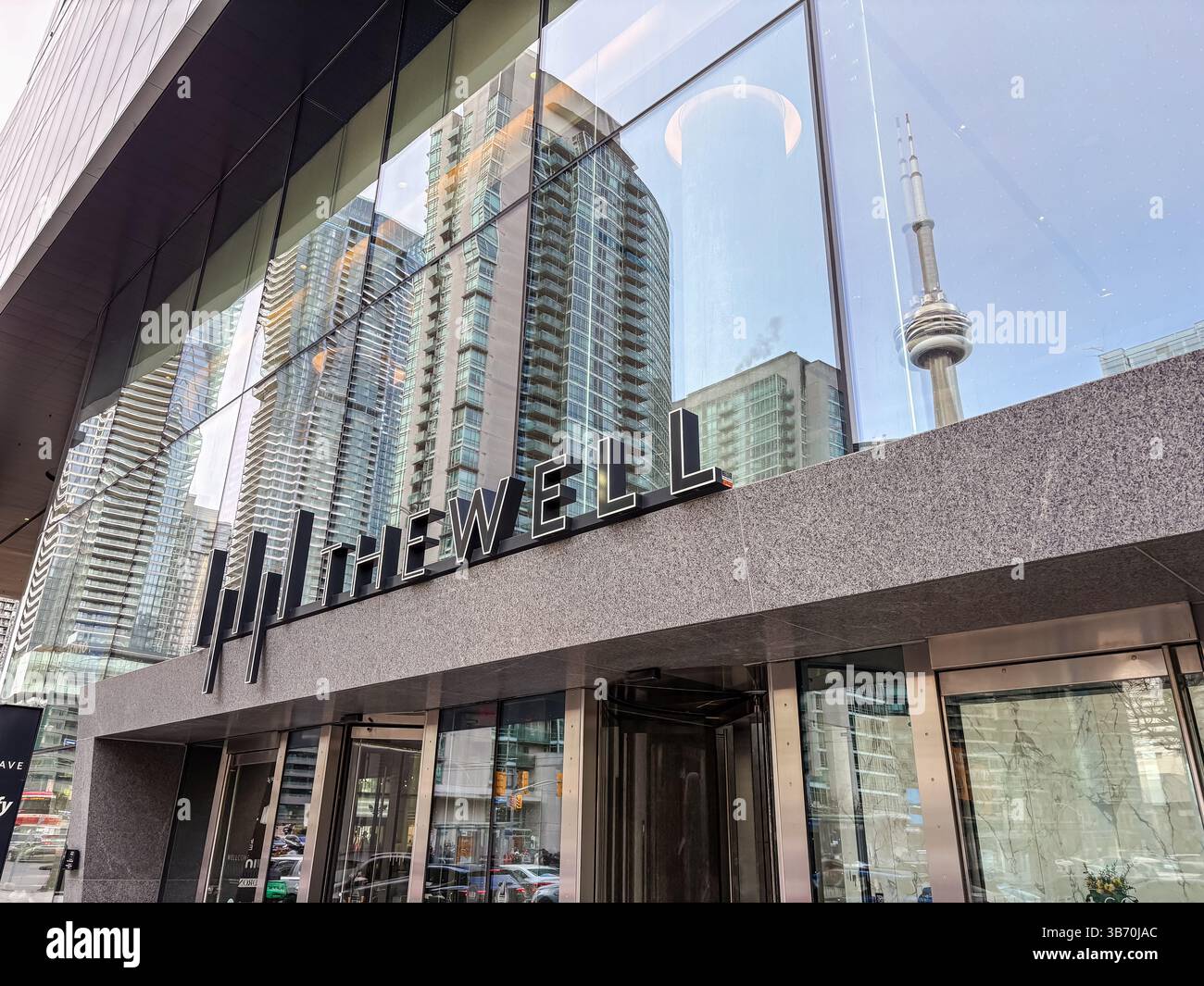 The Well. Exterior view of the modern mixed-use development in downtown Toronto, Canada, with reflections of the CN Tower and surrounding buildings in Stock Photo